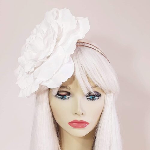 a classic white single flower headpiece for the races