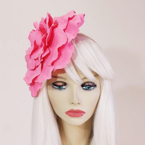 a beautiful candy pink flower headpiece for the races