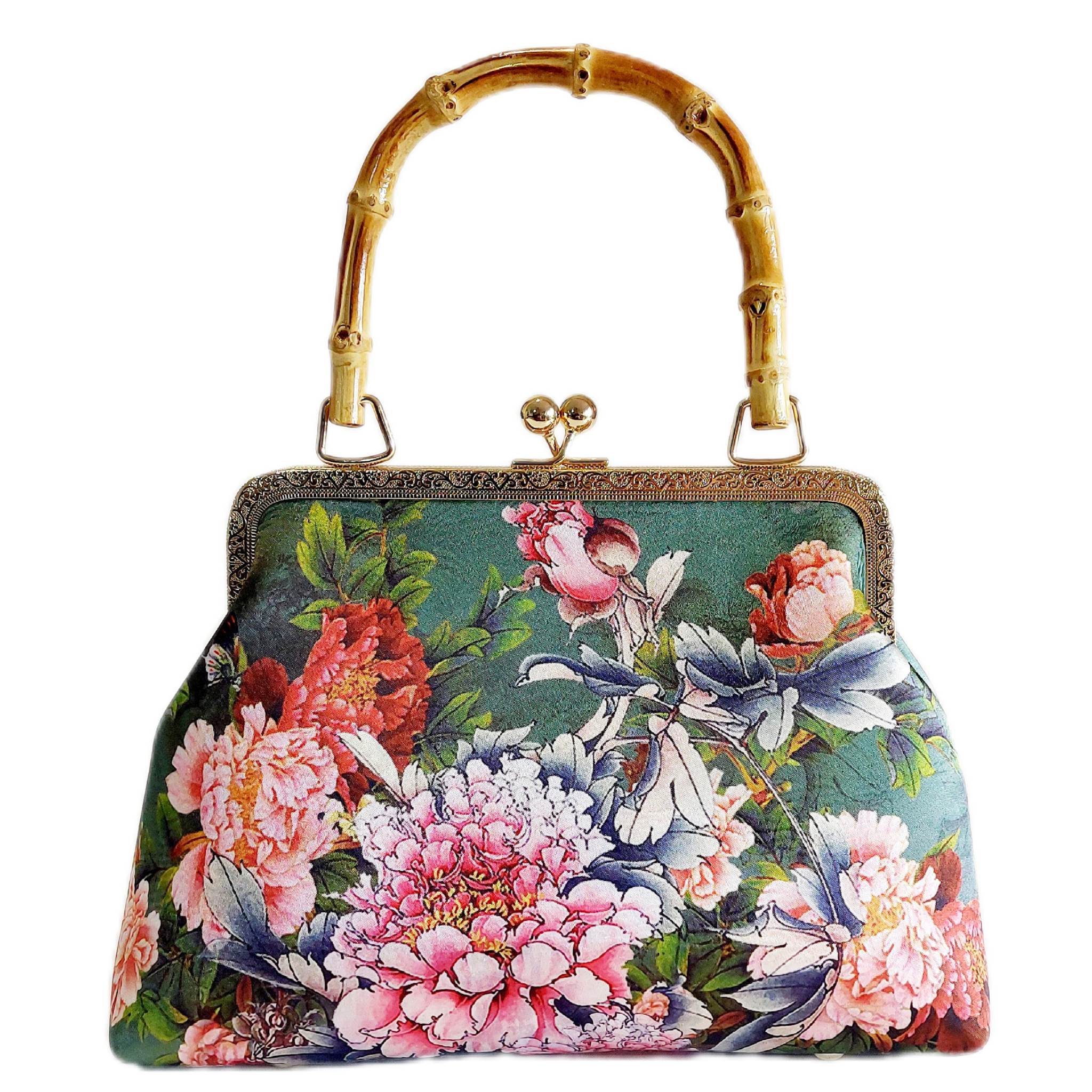 a beautiful satin floral print handbag with a bamboo handle